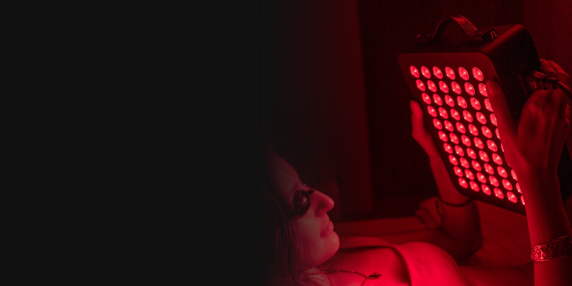 Woman using the ThermoLab Aura Pro 300W red light panel